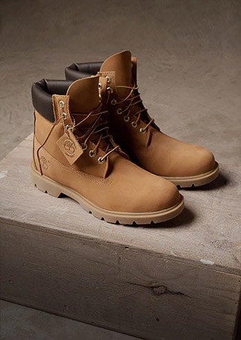 Timberland Basic 6" boot positioned neatly on a wood box with dramatic shadowing making it look classic and timeless.